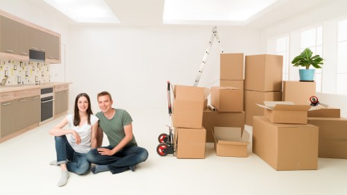 A professional moving team handling household items in a London neighborhood