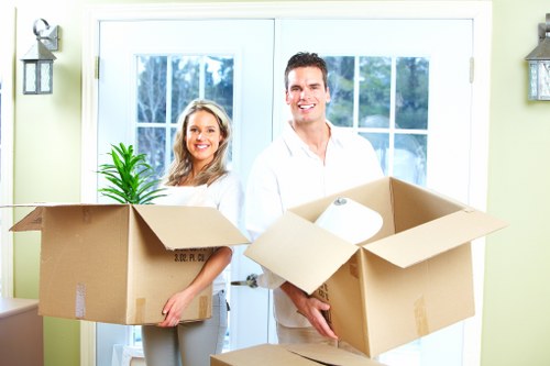 Professional movers dismantling and reassembling furniture